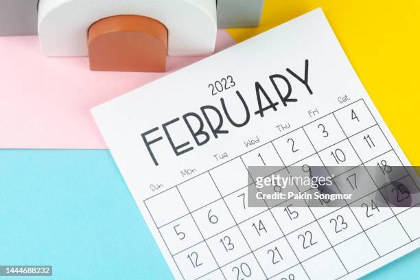 calendar desk 2023: february is the month for the organizer to plan and deadline with a two-tone paper background. - february stock pictures, royalty-free photos & images