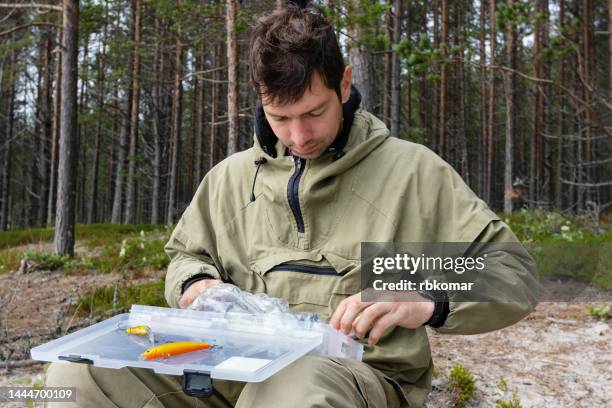 choice of bait and wobblers - fisherman with a box for fishing lures - fishing tackle box stock pictures, royalty-free photos & images