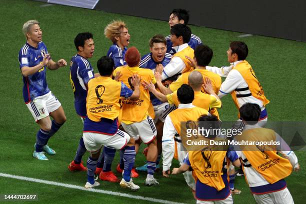 Ritsu Doan of Japan celebrates with team mates after scoring their team's first goal during the FIFA World Cup Qatar 2022 Group E match between...
