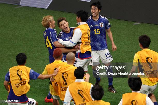 Ritsu Doan of Japan celebrates with team mates after scoring their team's first goal during the FIFA World Cup Qatar 2022 Group E match between...