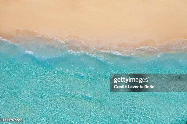 summer seascape beautiful waves, blue sea water in sunny day. top view from drone. sea aerial view, amazing tropical nature background. beautiful bright sea waves splashing and beach sand sunset light - beach sand stock pictures, royalty-free photos & images