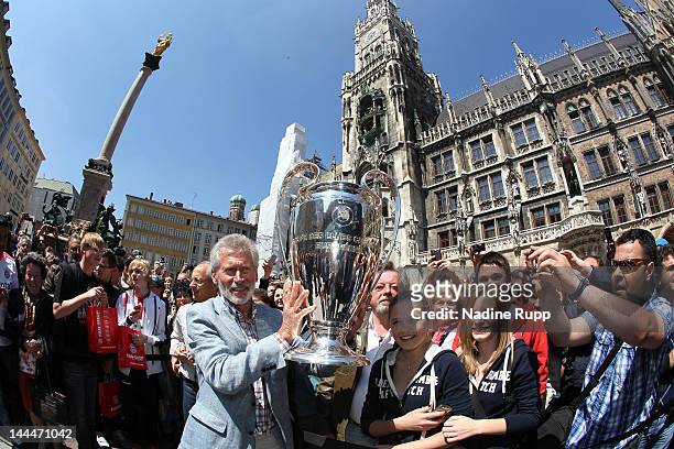 Ambassador Paul Breitner shows the trophy to the fans during the UEFA Champions League Trophy Tour Final at Marienplatz on May 14, 2012 in Munich,...