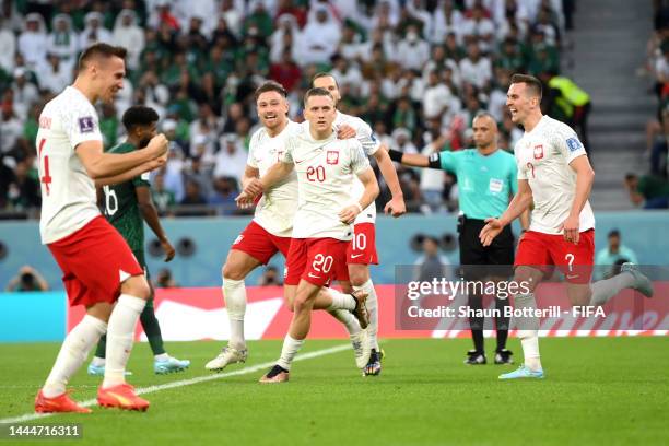 Piotr Zielinski of Poland celebrates with teammates after scoring their team's first goal during the FIFA World Cup Qatar 2022 Group C match between...