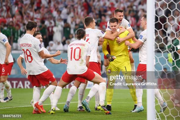 Wojciech Szczesny of Poland celebrates with teammates after saving a penalty by Salem Al-Dawsari of Saudi Arabia during the FIFA World Cup Qatar 2022...