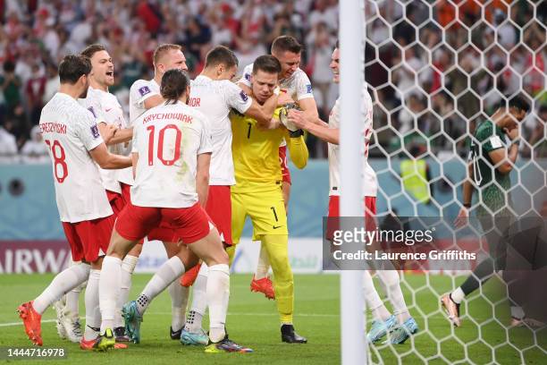 Wojciech Szczesny of Poland celebrates with teammates after saving a penalty by Salem Al-Dawsari of Saudi Arabia during the FIFA World Cup Qatar 2022...