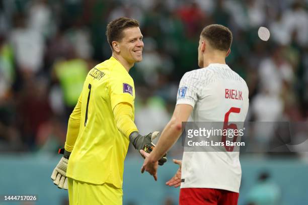 Wojciech Szczesny of Poland celebrates with Krystian Bielik after saving a penalty by Salem Al-Dawsari of Saudi Arabia during the FIFA World Cup...