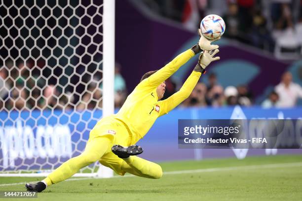 Wojciech Szczesny of Poland make a save the shot by Mohammed Alburayk of Saudi Arabia after the penalty kickduring the FIFA World Cup Qatar 2022...