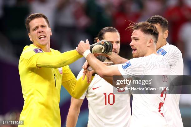 Wojciech Szczesny of Poland celebrates with teammates after saving a penalty by Salem Al-Dawsari of Saudi Arabia during the FIFA World Cup Qatar 2022...
