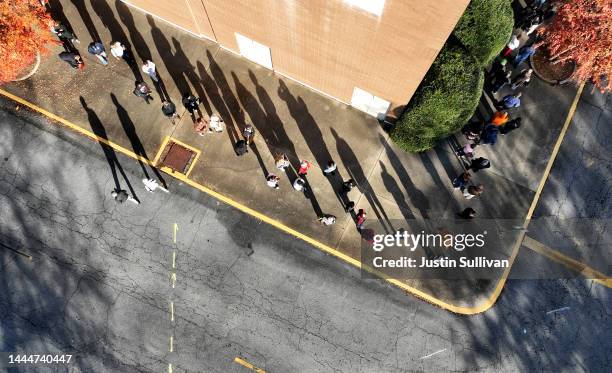 In an aerial view, voters line up to cast their ballots on November 26, 2022 in Decatur, Georgia. Early voting has started in select Georgia counties...