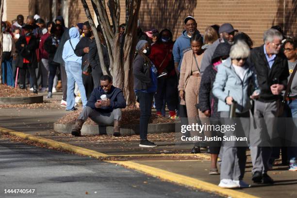 Voters line up to cast their ballots on November 26, 2022 in Decatur, Georgia. Early voting has started in select Georgia counties for a special...