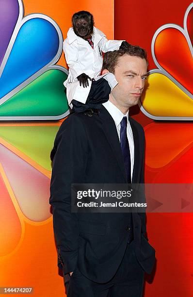 Crystal the Monkey and actor Justin Kirk attend NBC's Upfront Presentation at Radio City Music Hall on May 14, 2012 in New York City.