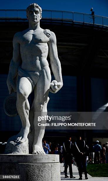 Italian Carabinieri military police officers stand by a statue of a tennis player, at the Italian Open Tennis Tournament , in Rome's Foro Italico on...