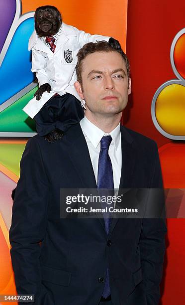 Crystal the Monkey and actor Justin Kirk attend NBC's Upfront Presentation at Radio City Music Hall on May 14, 2012 in New York City.