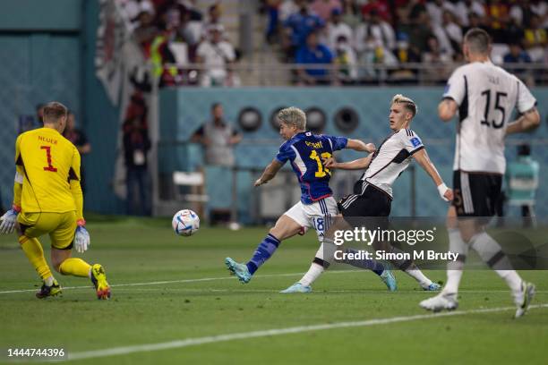 November, 23: Takuma Asano of Japan strikes the ball past Manuel Neuer of Germany to score a goal during the FIFA World Cup Qatar 2022 Group E match...