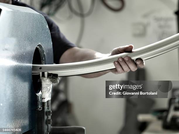 blacksmith in the workshop, bends a pipe - iron roll stock pictures, royalty-free photos & images