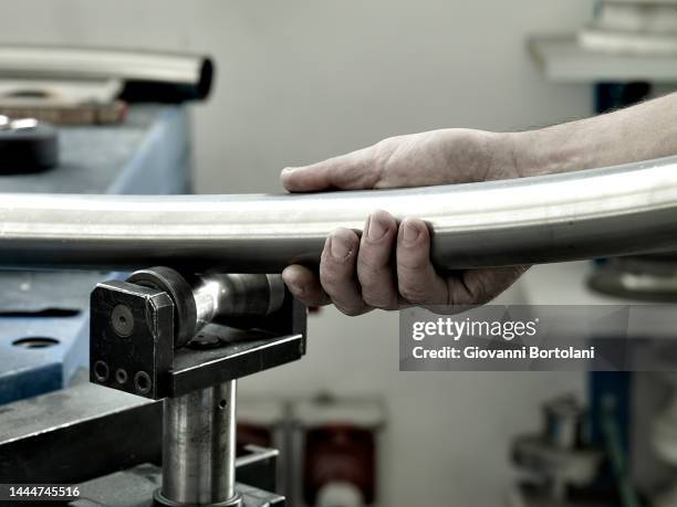 blacksmith in the workshop, bends a pipe - pipe bending stock pictures, royalty-free photos & images