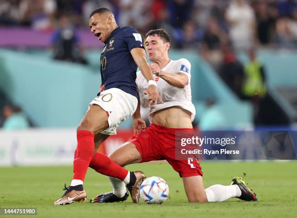 Kylian Mbappe of France is fouled by Andreas Christensen of Denmark resulting a yellow card during the FIFA World Cup Qatar 2022 Group D match...