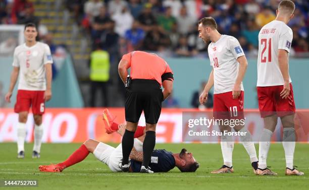Olivier Giroud of France lies on the pitch after the foul by Andreas Cornelius of Denmark during the FIFA World Cup Qatar 2022 Group D match between...