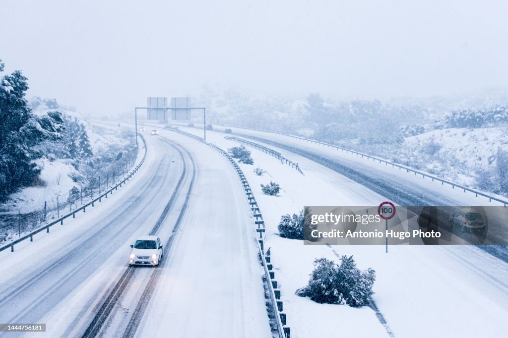 Cars driving on a snowy road.
