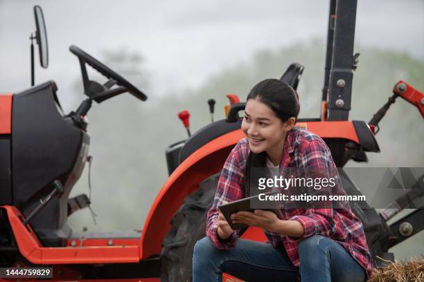 young smart farmer woman working in the garden with tractor. - drone isolated stock pictures, royalty-free photos & images