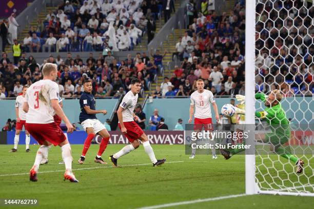 Kylian Mbappe of France scores their team's first goal during the FIFA World Cup Qatar 2022 Group D match between France and Denmark at Stadium 974...