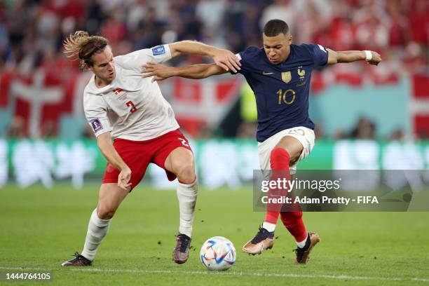 Kylian Mbappe of France takes on Joachim Andersen of Denmark during the FIFA World Cup Qatar 2022 Group D match between France and Denmark at Stadium...