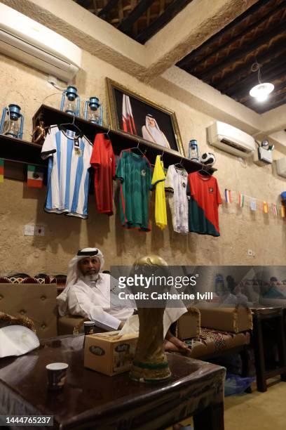 Home made replica World Cup trophy is displayed in a room as people watch the football during the FIFA World Cup Qatar 2022 at Souq Waqif on November...
