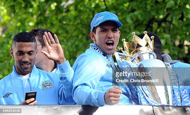 Sergio Aguero of Manchester City celebrates with the Barclays Premier League trophy next to team-mate Gael Clichy in front of Manchester Town Hall...