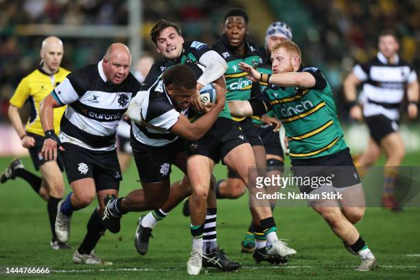 Tevita Ikanivere of Barbarian is tackled by Matthew Arden of Northampton Saints during the friendly match between Northampton Saints and Barbarians...