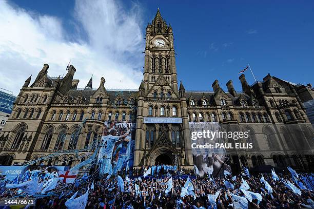 Manchester City players stand with their manager Roberto Mancini as they celebrate becoming English Premier League champions in a parade leaving from...