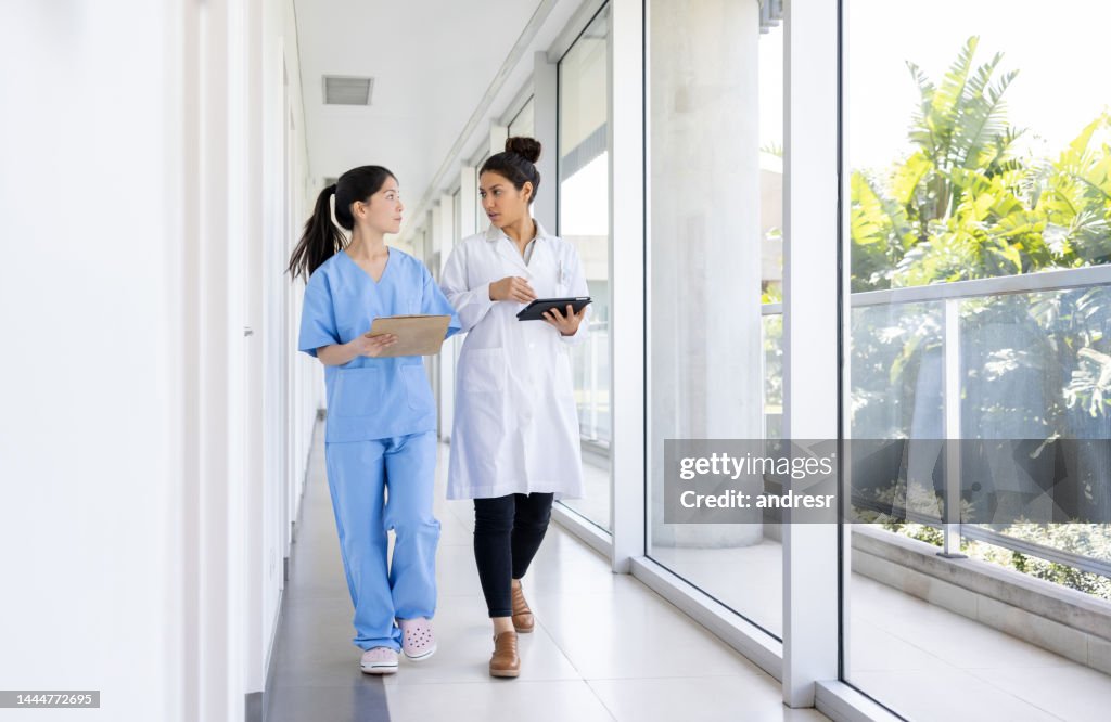 Doctor talking to a nurse in the corridor the hospital