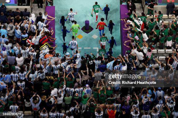 Lionel Messi of Argentina and Andres Guardado of Mexico lead their teams entering the pitch prior to the FIFA World Cup Qatar 2022 Group C match...