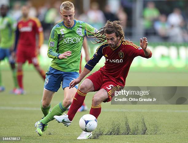 Kyle Beckerman of Real Salt Lake dribbles against Andy Rose of the Seattle Sounders at CenturyLink Field on May 12, 2012 in Seattle, Washington.