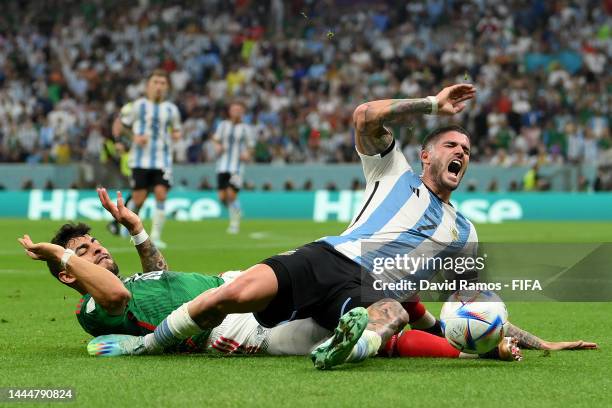 Rodrigo De Paul of Argentina is tackled by Alexis Vega of Mexico during the FIFA World Cup Qatar 2022 Group C match between Argentina and Mexico at...