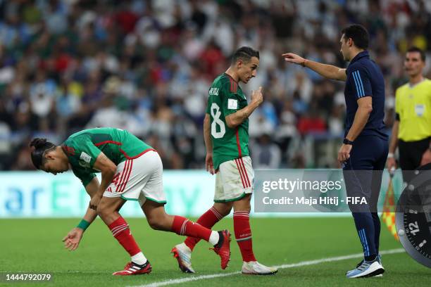 Erick Gutierrez and Andres Guardado of Mexico react as they are substituted during the FIFA World Cup Qatar 2022 Group C match between Argentina and...