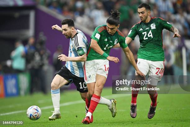 Lionel Messi of Argentina battles for possession with Erick Gutierrez and Luis Chavez of Mexico during the FIFA World Cup Qatar 2022 Group C match...