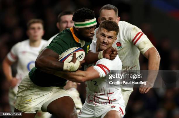 Siya Kolisi of South Africa is tackled by Henry Slade of England during the Autumn International match between England and South Africa at Twickenham...