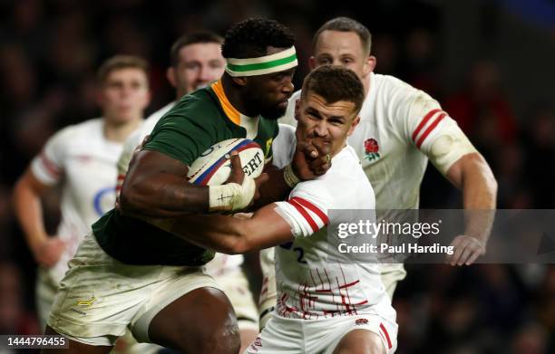 Siya Kolisi of South Africa is tackled by Henry Slade of England during the Autumn International match between England and South Africa at Twickenham...