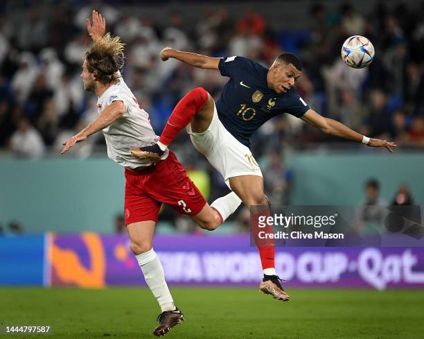 Joachim Andersen of Denmark competes for a header against Kylian Mbappe of France during the FIFA World Cup Qatar 2022 Group D match between France...