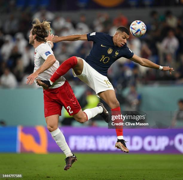 Joachim Andersen of Denmark competes for a header against Kylian Mbappe of France during the FIFA World Cup Qatar 2022 Group D match between France...
