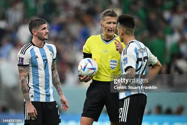 Referee Daniele Orsato speaks with Rodrigo De Paul and Lautaro Martinez of Argentina during the FIFA World Cup Qatar 2022 Group C match between...
