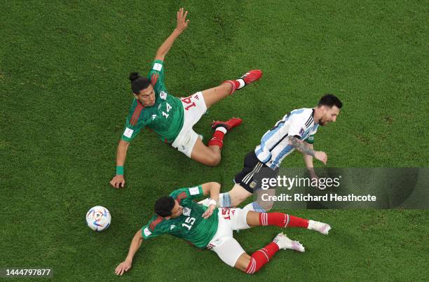 Lionel Messi of Argentina is brought down by Erick Gutierrez of Mexico during the FIFA World Cup Qatar 2022 Group C match between Argentina and...