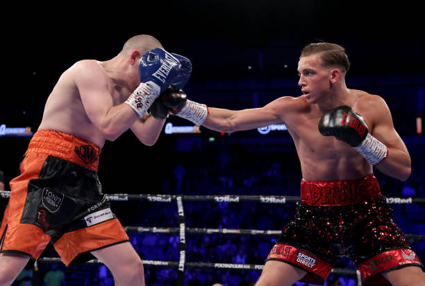 Dennis McCann of Great Britain exchanges punches with Joe Ham of Scotland during their Commonwealth Super Bantamweight fight at The O2 Arena on...