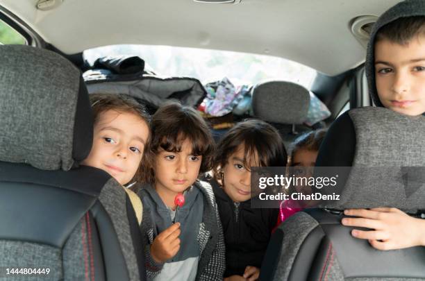 children cramped in the back seat of the car - car going in circles stock pictures, royalty-free photos & images