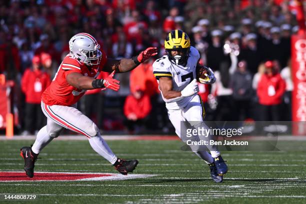 Donovan Edwards of the Michigan Wolverines runs with the ball during the third quarter of a game against the Ohio State Buckeyes at Ohio Stadium on...