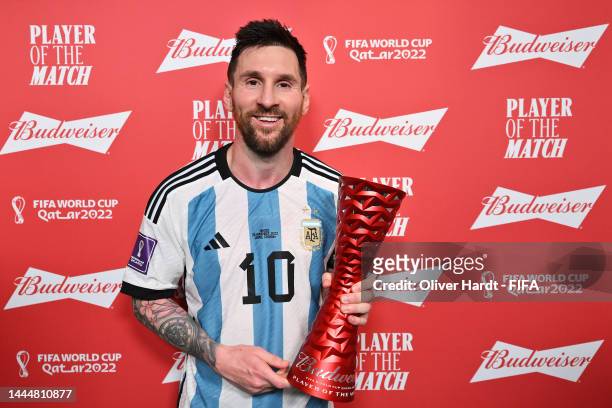 Lionel Messi of Argentina poses with the Budweiser Player of the Match Trophy following the FIFA World Cup Qatar 2022 Group C match between Argentina...