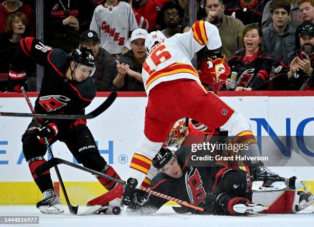 Paul Stastny of the Carolina Hurricanes battles Nikita Zadorov of the Calgary Flames for the puck in front of the net during the first period of...