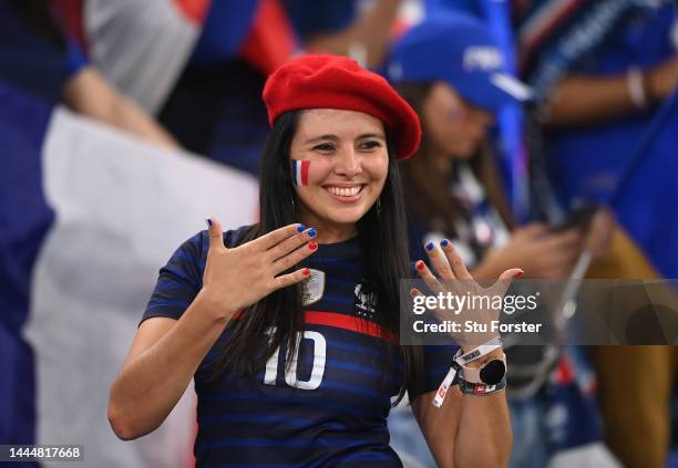 France fan wearing a beret and painted nails smiles ahead of the FIFA World Cup Qatar 2022 Group D match between France and Denmark at Stadium 974 on...