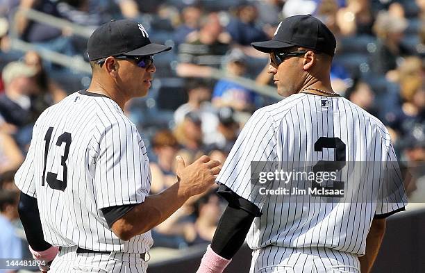 Derek Jeter and Alex Rodriguez of the New York Yankees talk during a pitching change against the Seattle Mariners at Yankee Stadium on May 13, 2012...
