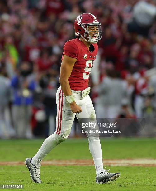 Bryce Young of the Alabama Crimson Tide reacts after passing for a touchdown to Traeshon Holden against the Auburn Tigers during the first half at...